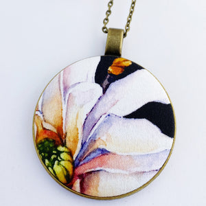 large pendant necklace, brass- on long bronze chain- with fabric feature- offset Magnolia on black- Hey Jude Handmade