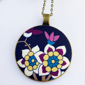 large pendant necklace, brass- on long bronze chain- with fabric feature- navy with white purple yellow blue floral- Hey Jude Handmade